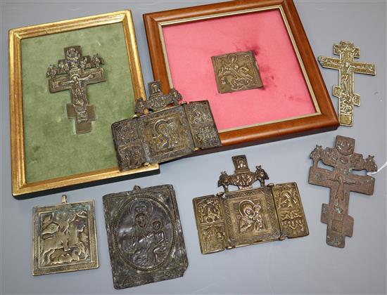 Eight 19th century Russian brass or copper crucifixes or icons